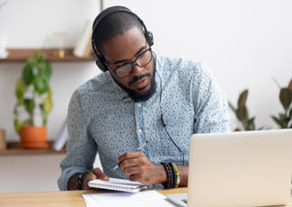 man with phone and laptop