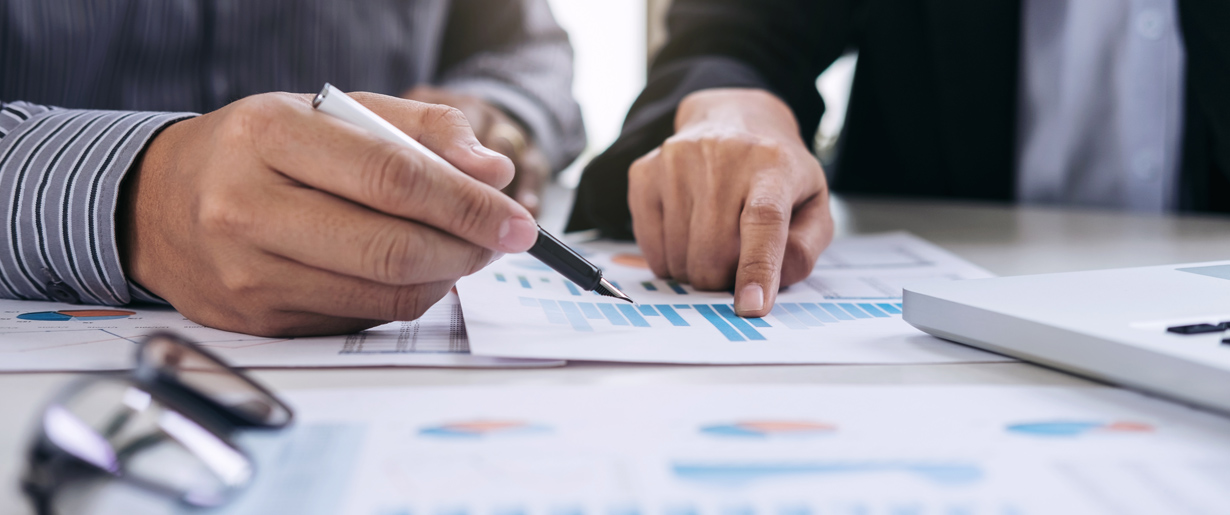 2 members of finance reviewing paperwork