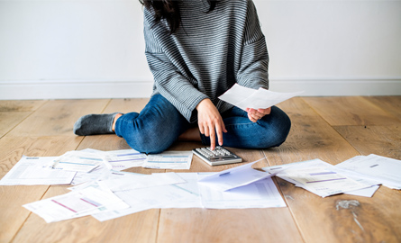 Woman on floor with bills