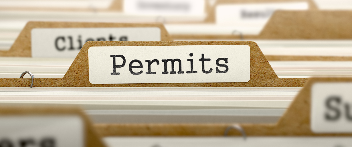 A file folder with the word permit