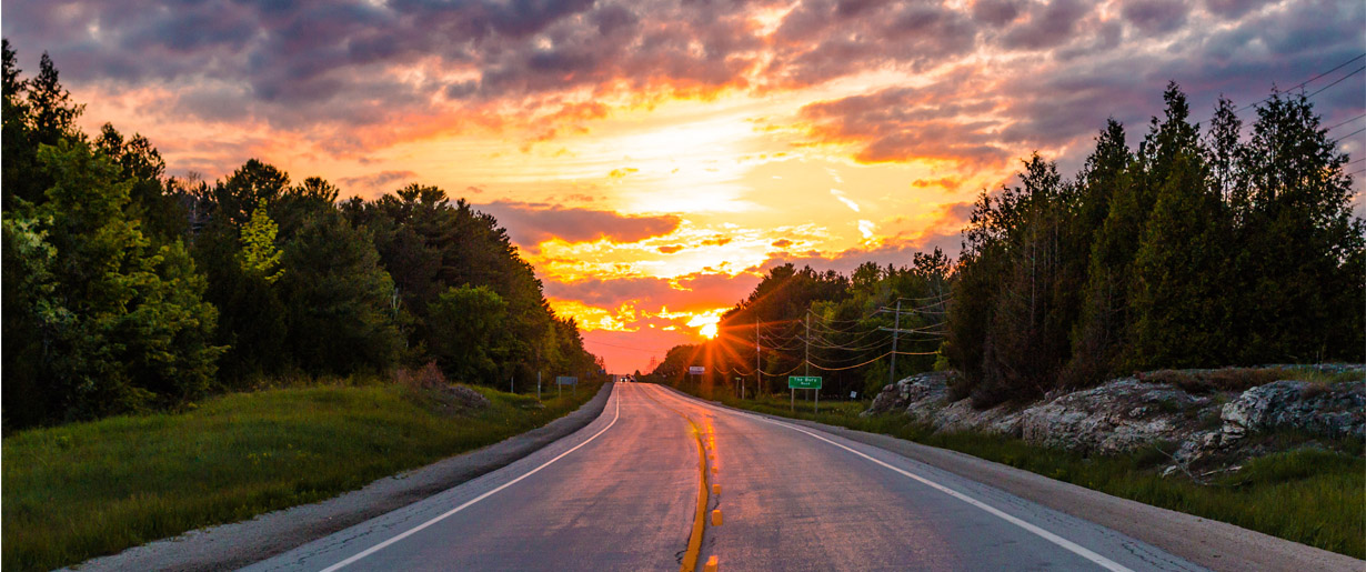 a road curving away to the sunset