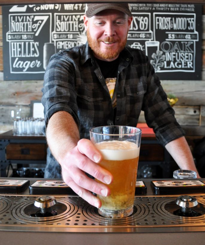 a man serving beer