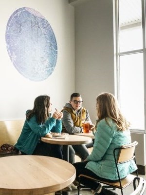 three people eating together
