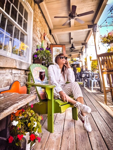 a girl sits outside a restaurant