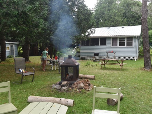 a girl bbq outside a cottage