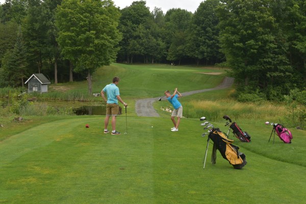 two boys playing golf