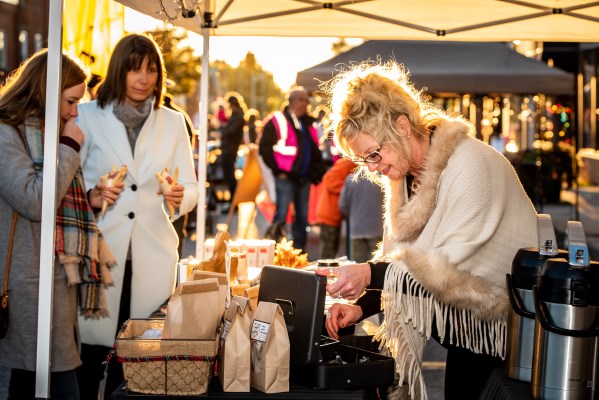 two people buying present from local vendor