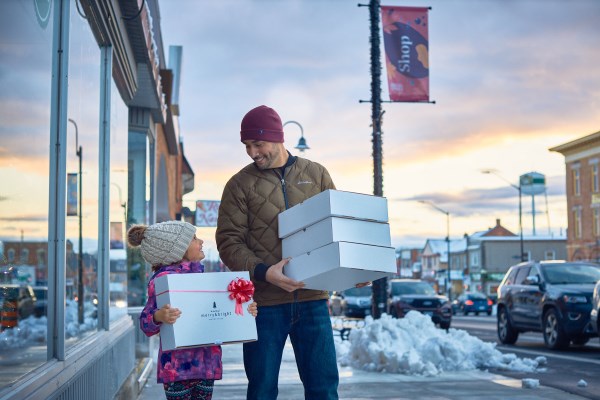 a father and daughter holding the presents they bought 