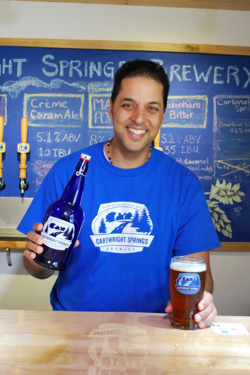 A skilled staff member pours beer at Cartwright Springs Brewery