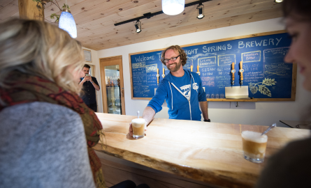 a man serving a beer