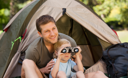 a man and child in a tent