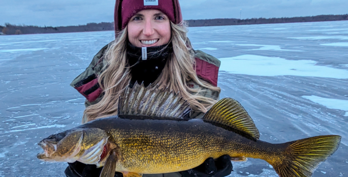 a woman holding a fish