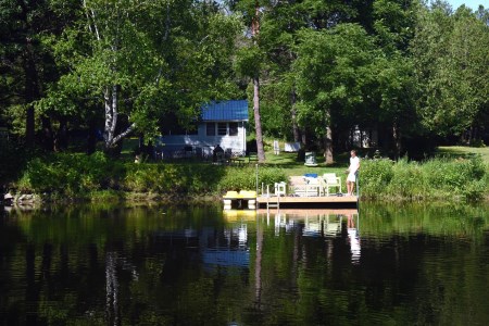 one person standing on a lakeside