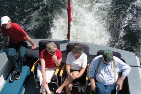 four people sitting a stern