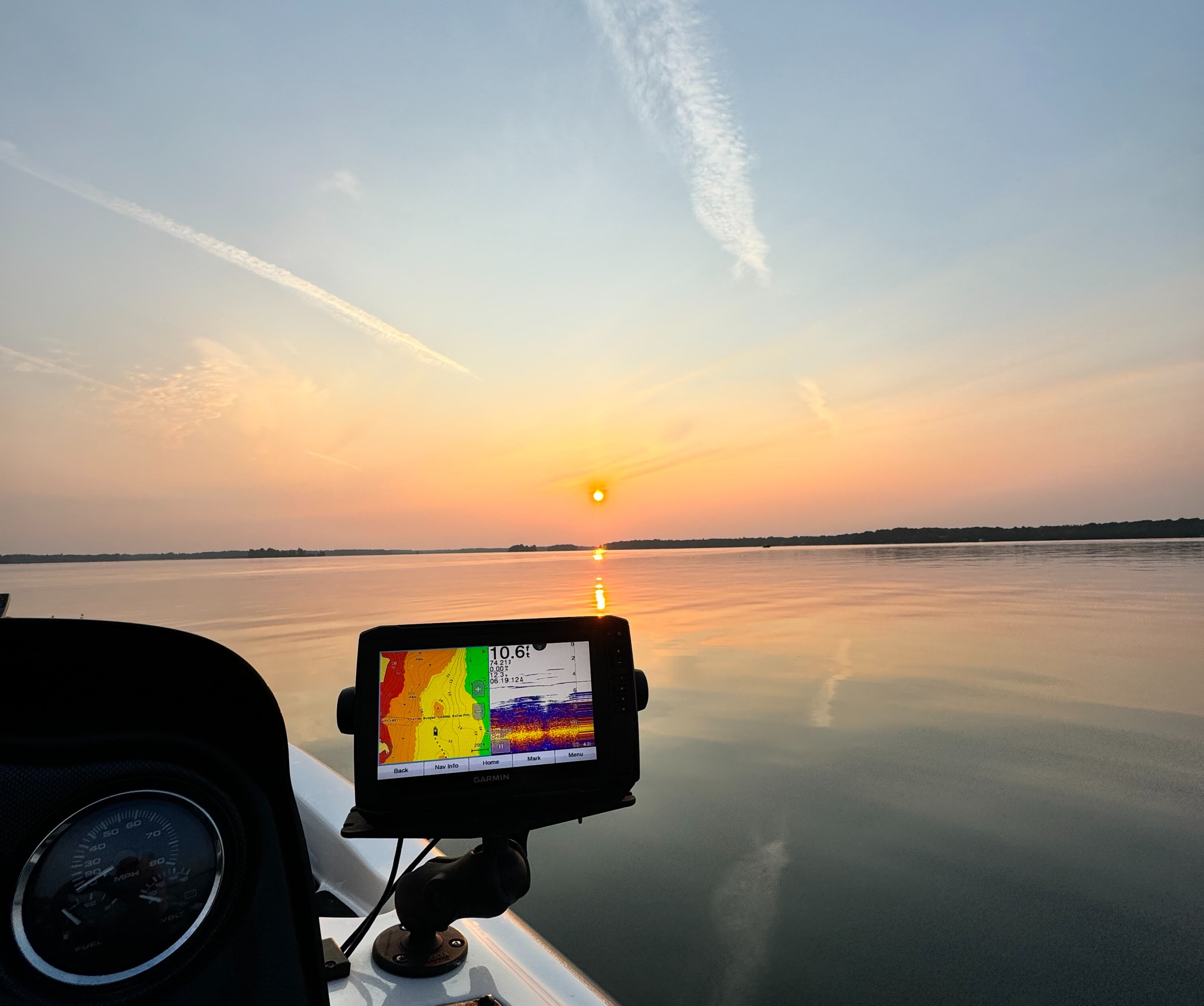 Sunrise of a lake off of a boat. 