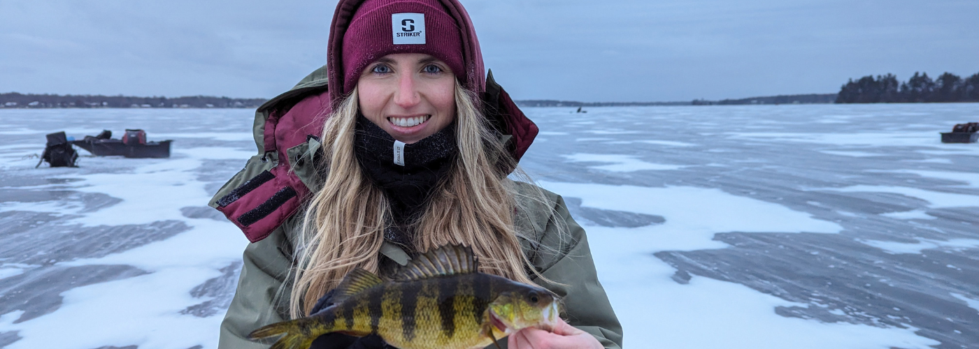 a woman holding a fish