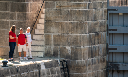 three people on a stone lock 