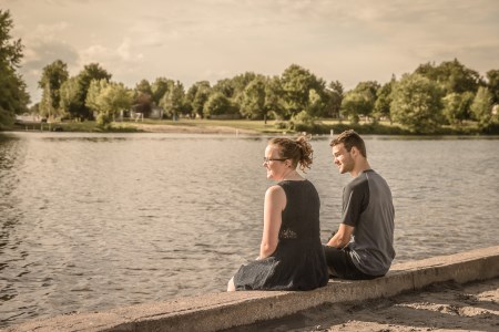 Two people sitting next to a river in Carleton Place