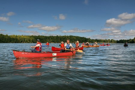 a group fo people paddling on the water