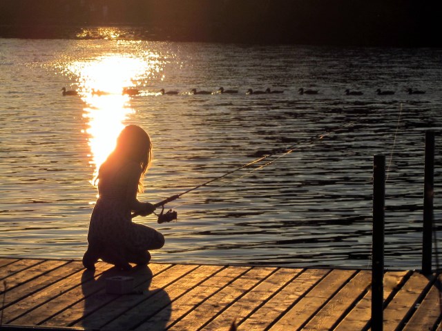 a woman fishing on a river