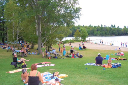 people having picnic and fun time next to a beach