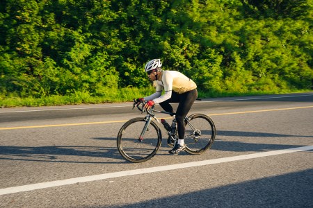 a man cycling on a road
