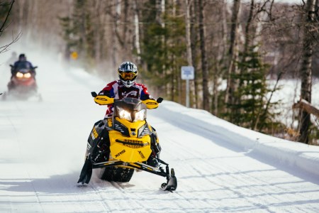 a man snowmobiling in winter