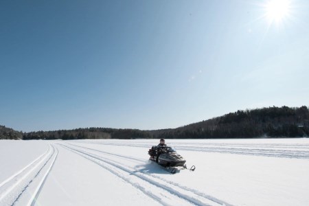 A man snowmobiling 