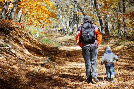 a parent goes hiking with a kid