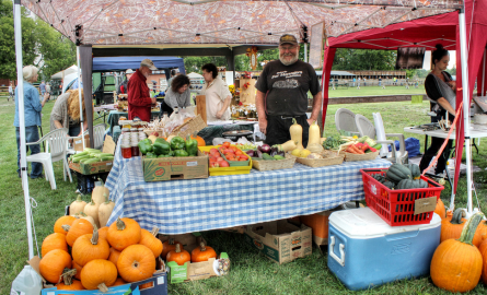 a man at a farmers market stand