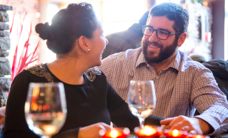 a man and a woman enjoying a meal at a restaurant