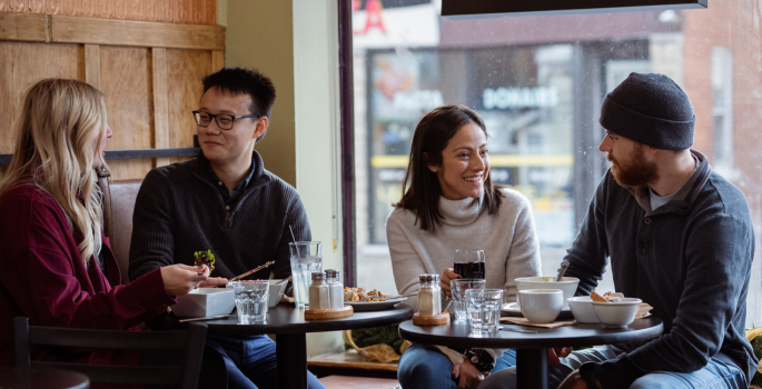 four people eating at a restaurant