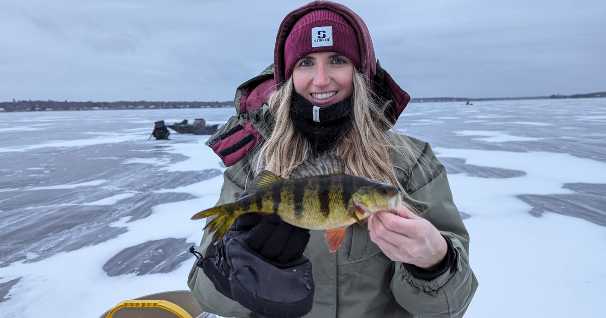 a woman holding a fish